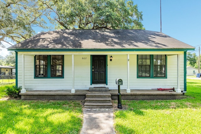 bungalow featuring a porch and a front yard