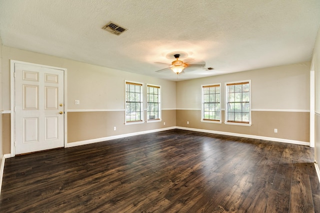 spare room featuring ceiling fan, dark hardwood / wood-style flooring, and a textured ceiling