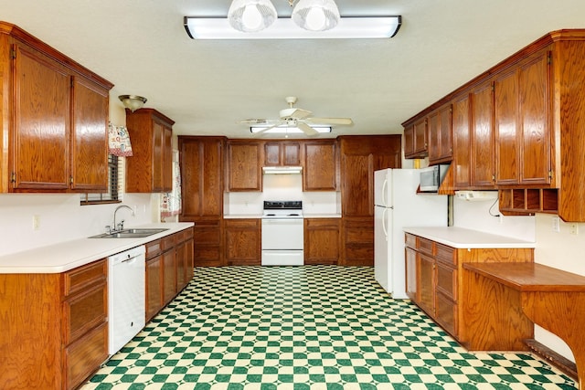 kitchen featuring white appliances, ceiling fan, and sink