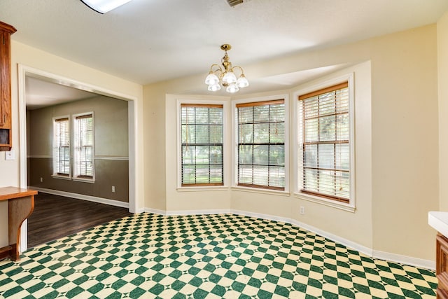 unfurnished dining area featuring a notable chandelier