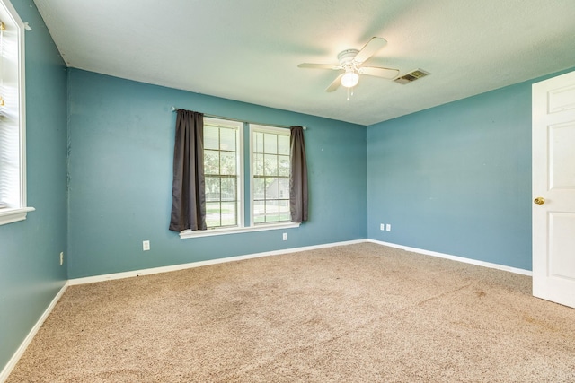 spare room with ceiling fan and carpet floors