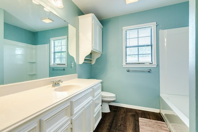 full bathroom featuring wood-type flooring, vanity, toilet, and a healthy amount of sunlight