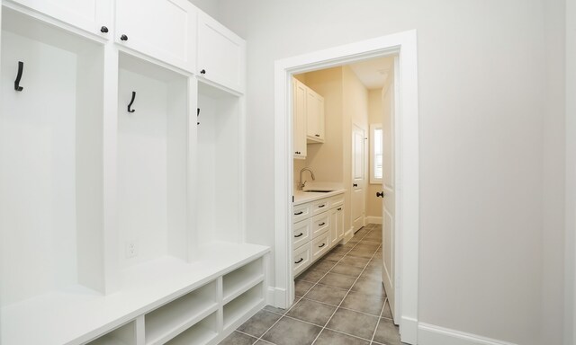 mudroom featuring tile patterned floors and sink