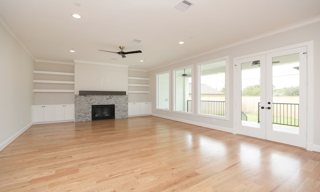 unfurnished living room featuring built in features, ornamental molding, light wood-type flooring, and ceiling fan