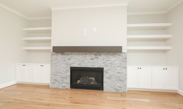 interior details with crown molding, hardwood / wood-style flooring, and a fireplace