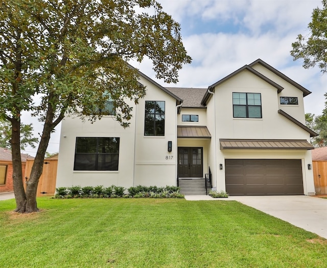 view of front of property featuring a front lawn and a garage