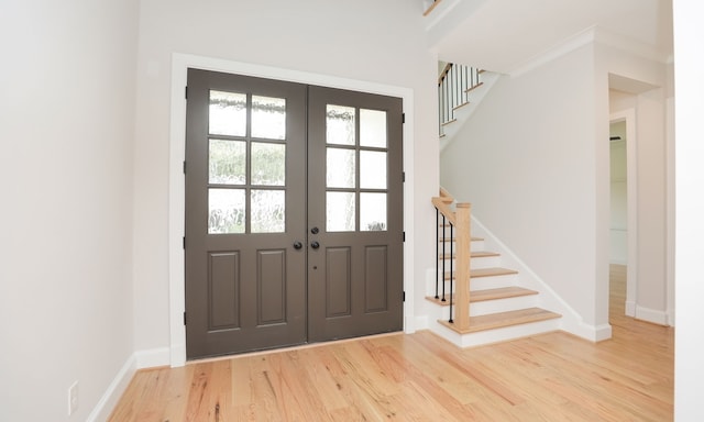 foyer entrance with french doors and wood-type flooring