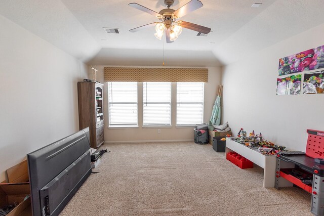 recreation room with carpet flooring, ceiling fan, and vaulted ceiling