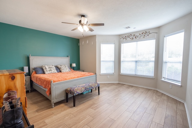 bedroom with light hardwood / wood-style flooring and ceiling fan