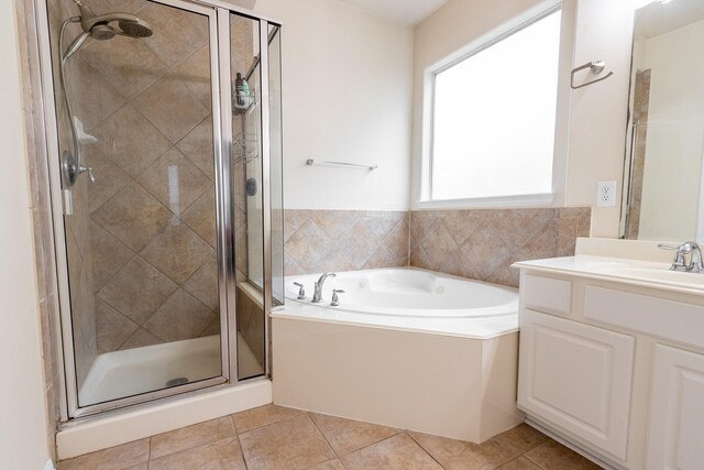 bathroom featuring independent shower and bath, vanity, and tile patterned flooring