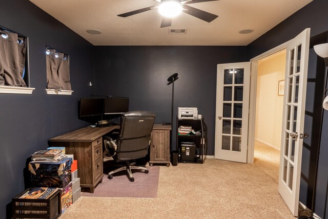 home office featuring light carpet, french doors, and ceiling fan