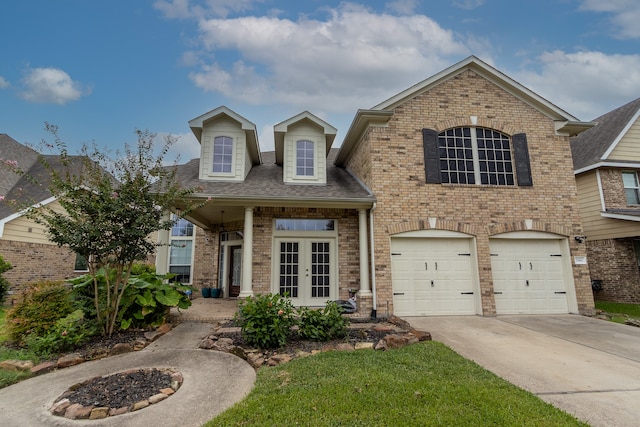 view of front of home with a garage and french doors