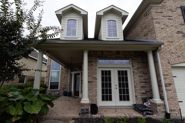 entrance to property with a garage and french doors