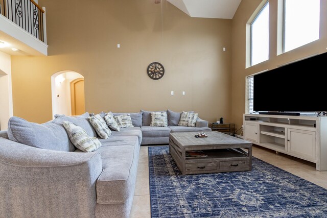 tiled living room with a high ceiling