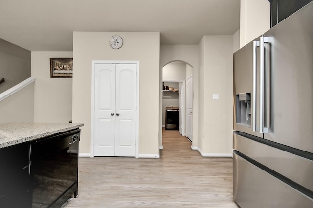 kitchen featuring black dishwasher, high end refrigerator, and light wood-type flooring