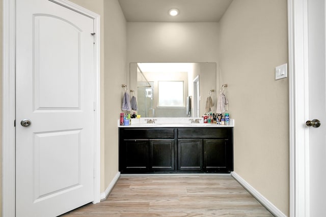 bathroom featuring hardwood / wood-style flooring and vanity