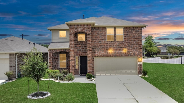 front facade featuring a garage and a yard