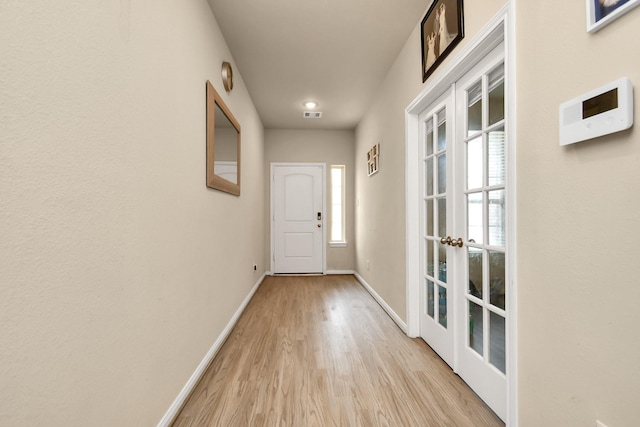 entryway featuring french doors and light wood-type flooring