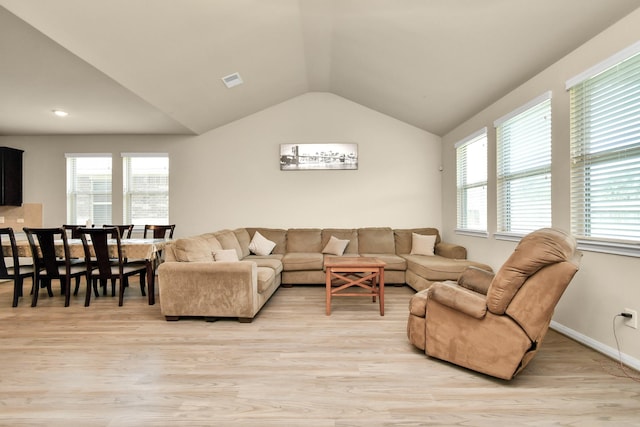 living room with vaulted ceiling and light hardwood / wood-style floors