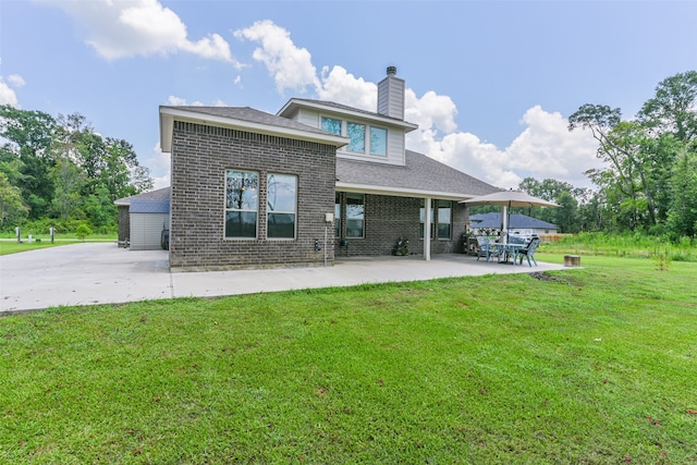 back of house with a lawn and a patio