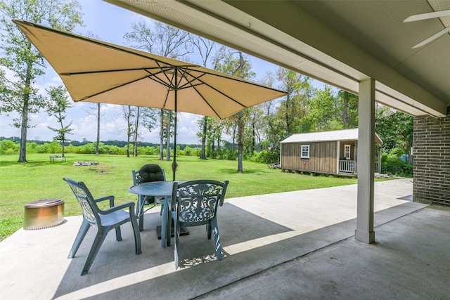 view of patio / terrace with ceiling fan and an outdoor structure