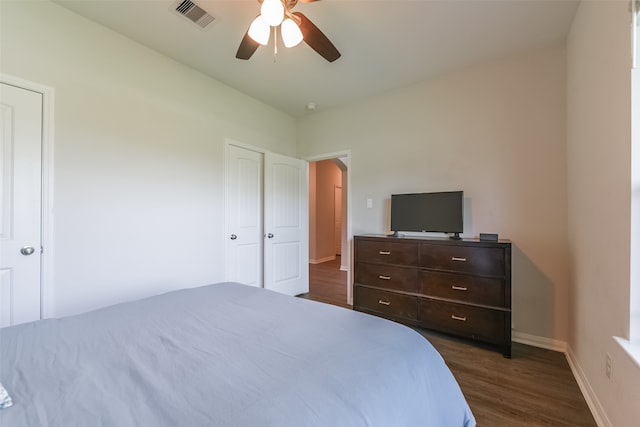 bedroom with ceiling fan and dark hardwood / wood-style flooring