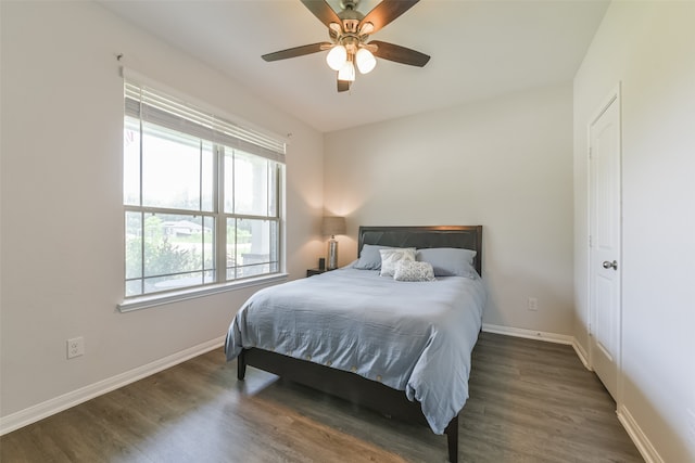 bedroom with ceiling fan and dark hardwood / wood-style flooring