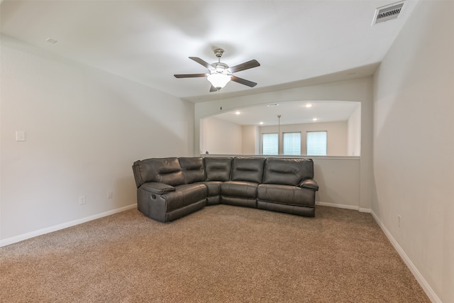 carpeted living room with ceiling fan