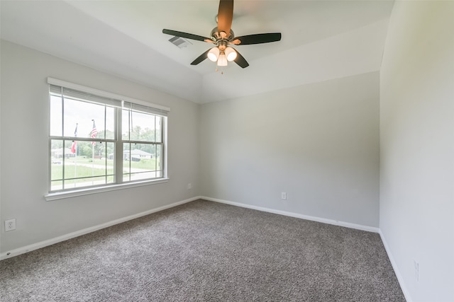 carpeted empty room featuring ceiling fan and vaulted ceiling