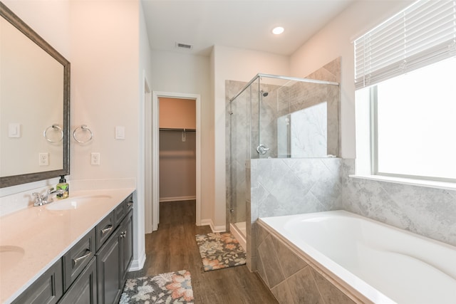 bathroom featuring vanity, hardwood / wood-style flooring, and independent shower and bath