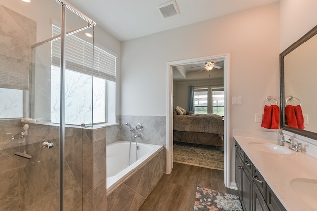 bathroom with hardwood / wood-style floors, vanity, ceiling fan, and independent shower and bath