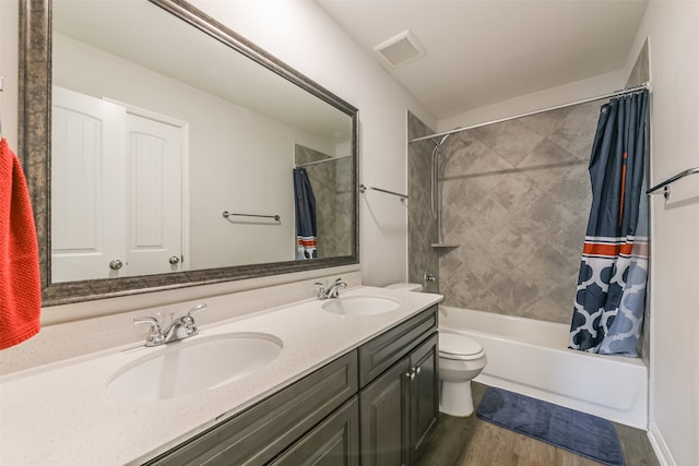 full bathroom with vanity, hardwood / wood-style floors, shower / bathtub combination with curtain, and toilet