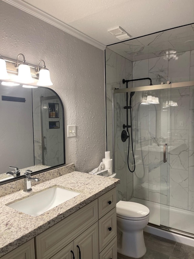 bathroom with crown molding, vanity, a textured ceiling, toilet, and walk in shower