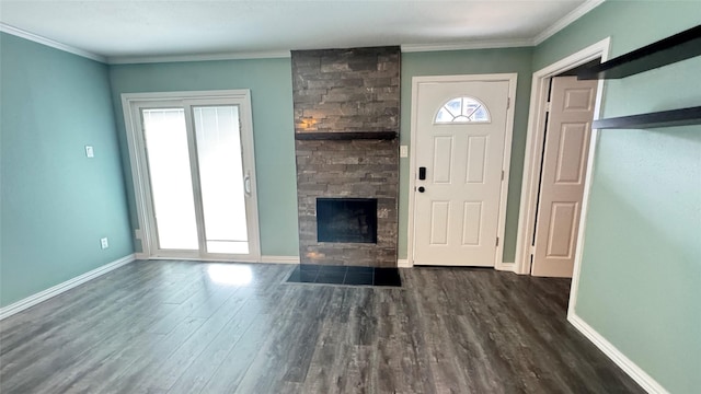 entrance foyer featuring ornamental molding, a large fireplace, and dark hardwood / wood-style flooring