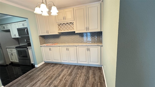 kitchen featuring hanging light fixtures, ornamental molding, tasteful backsplash, stainless steel appliances, and a chandelier