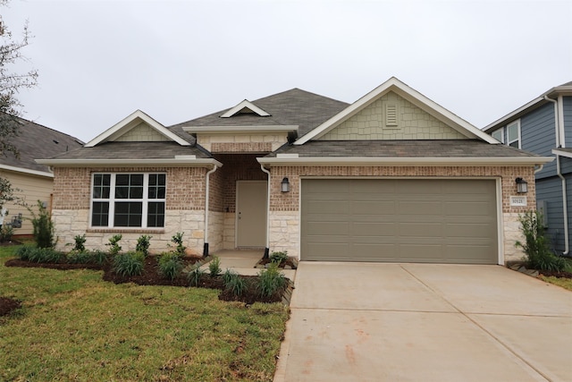 view of front of property with a garage and a front yard