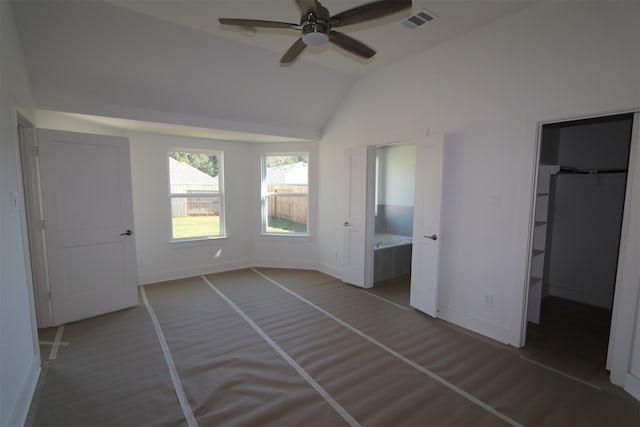 unfurnished bedroom with ensuite bath, ceiling fan, and lofted ceiling