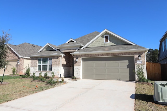 view of front of property featuring a garage, ac unit, and a front yard