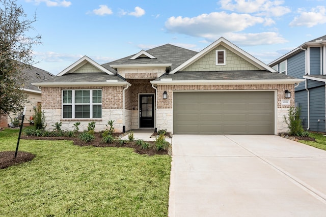 view of front of home featuring driveway, a shingled roof, an attached garage, a front yard, and brick siding