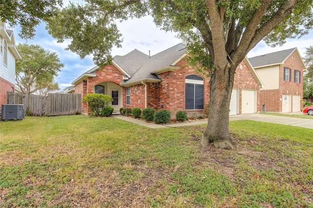 view of front of property featuring a front yard, a garage, and central air condition unit