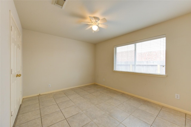 tiled spare room with ceiling fan