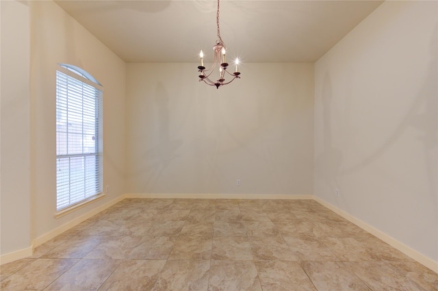 empty room featuring a chandelier