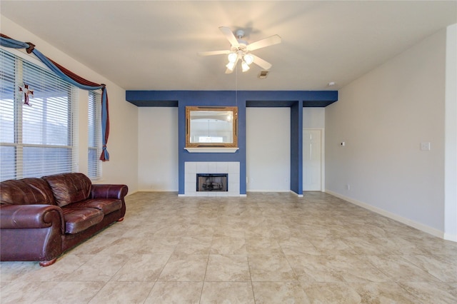 living room with ceiling fan and a fireplace