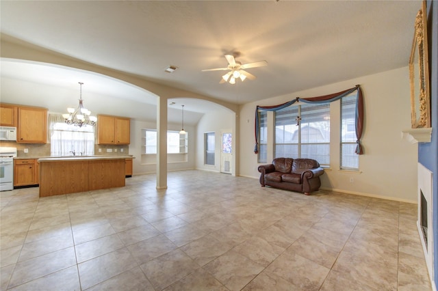 unfurnished living room featuring ceiling fan with notable chandelier and light tile patterned flooring