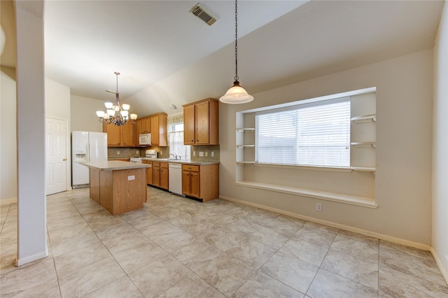 kitchen with backsplash, white appliances, a center island, hanging light fixtures, and lofted ceiling