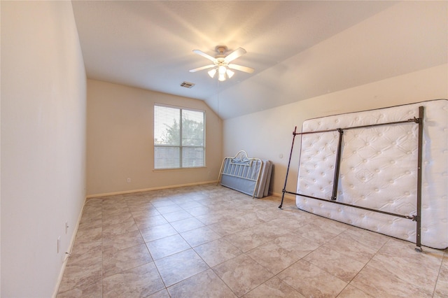 interior space featuring light tile patterned floors, ceiling fan, and lofted ceiling