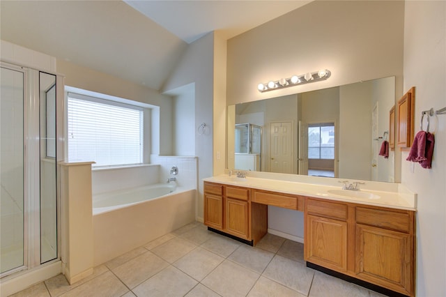 bathroom with tile patterned floors, vanity, and shower with separate bathtub