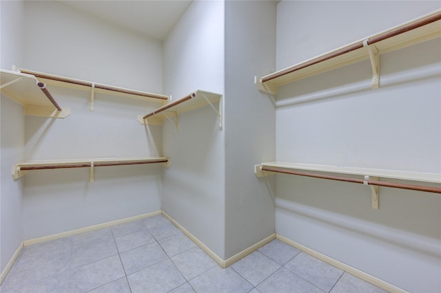 walk in closet featuring light tile patterned flooring