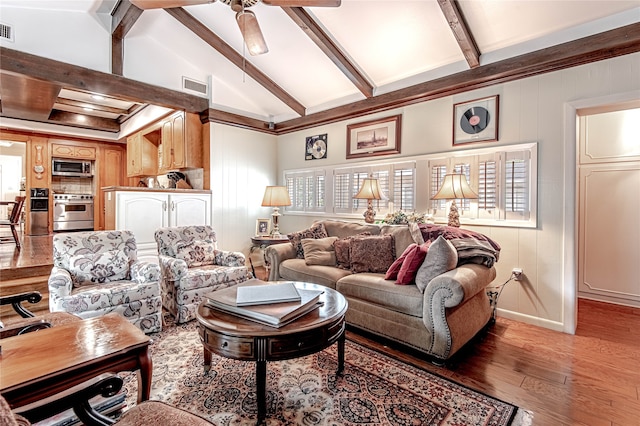 living room featuring lofted ceiling with beams, hardwood / wood-style floors, and ceiling fan