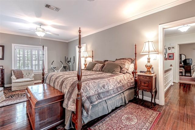 bedroom featuring dark wood-type flooring, ceiling fan, and ornamental molding